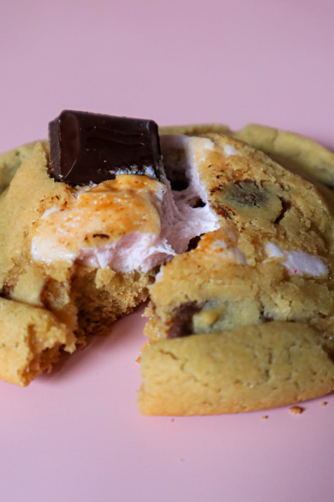A salted caramel filled cookie torn open showing the oozing caramel centre